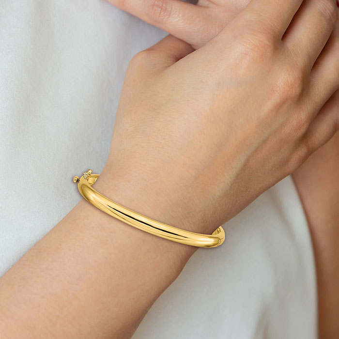 14k solid gold hinged bangle bracelet on wrist
